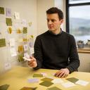 Process architect reviewing a workflow board in a Wick office